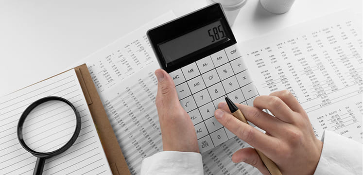 Man calculating budget on calculator